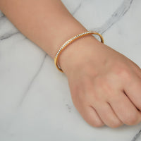 Gold Plated Stainless Steel Channel Set Bangle Created with Zircondia® Crystals (7 Inch)