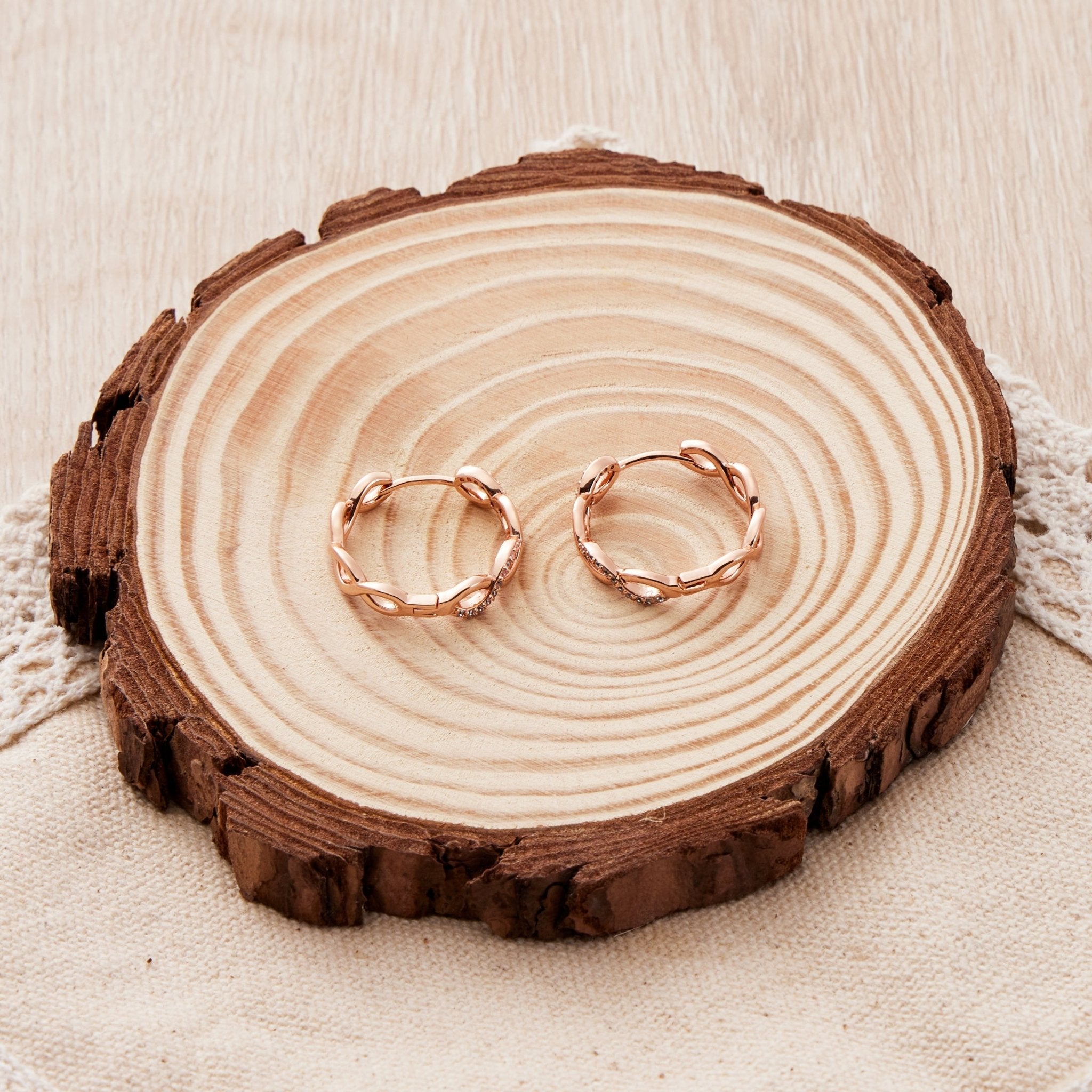 Rose Gold Plated Infinity Hoop Earrings Created with Zircondia® Crystals