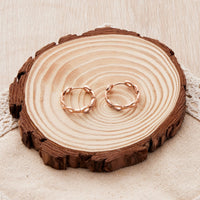 Rose Gold Plated Infinity Hoop Earrings Created with Zircondia® Crystals