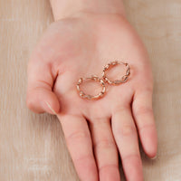 Rose Gold Plated Infinity Hoop Earrings Created with Zircondia® Crystals